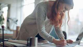 Woman at table doing paperwork