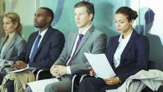 Men and women in business attire in waiting room