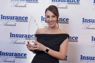 Sare Ozkara holding trophy as a winner at the Business Insurance Awards 2024