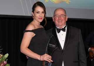 Sare Ozkara and Rich Fenton holding winners trophy at Business Insurance Awards 2024