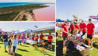 Community event with volunteers in red shirts running stalls under tents, alongside a scenic aerial view of a coastal landscape and pink lake.