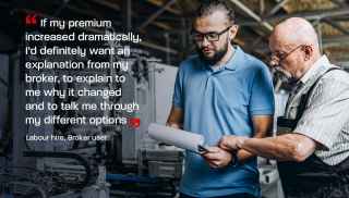 Two people having discussion something over paper in a factory.