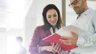 A woman &amp; Man discussing something over brochure