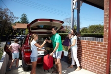 A family packing bags into the car
