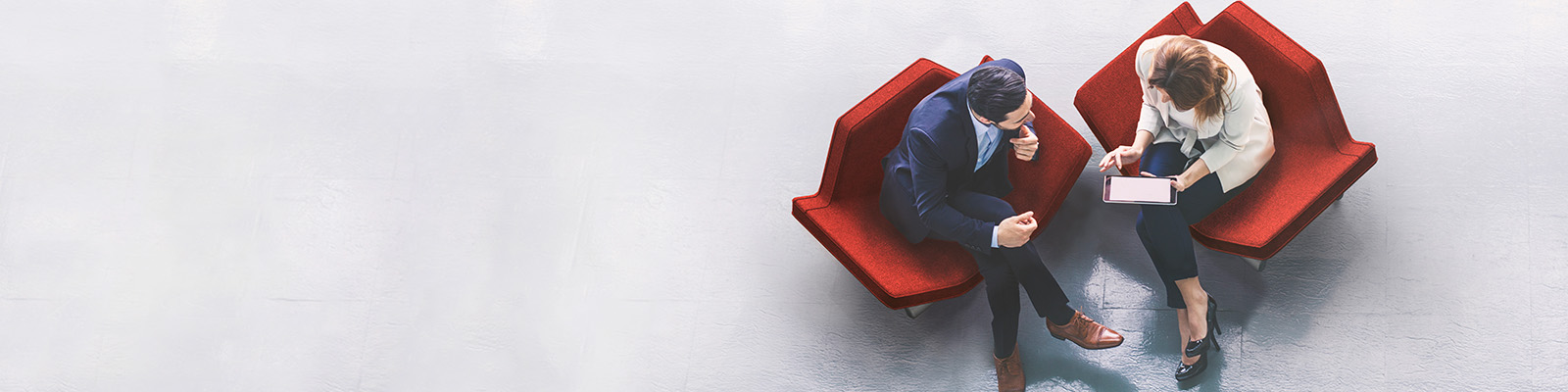 Aerial view of a man and woman sitting on red chairs