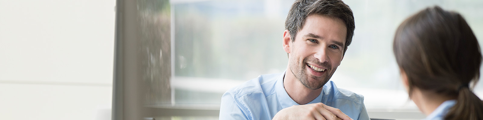 Corporate man smiling at a woman