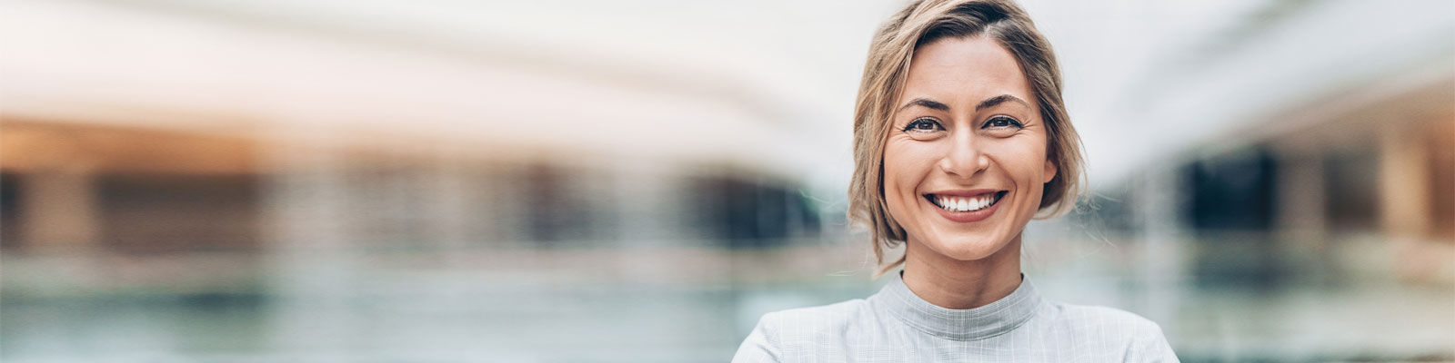 Woman smiling with blurred building background
