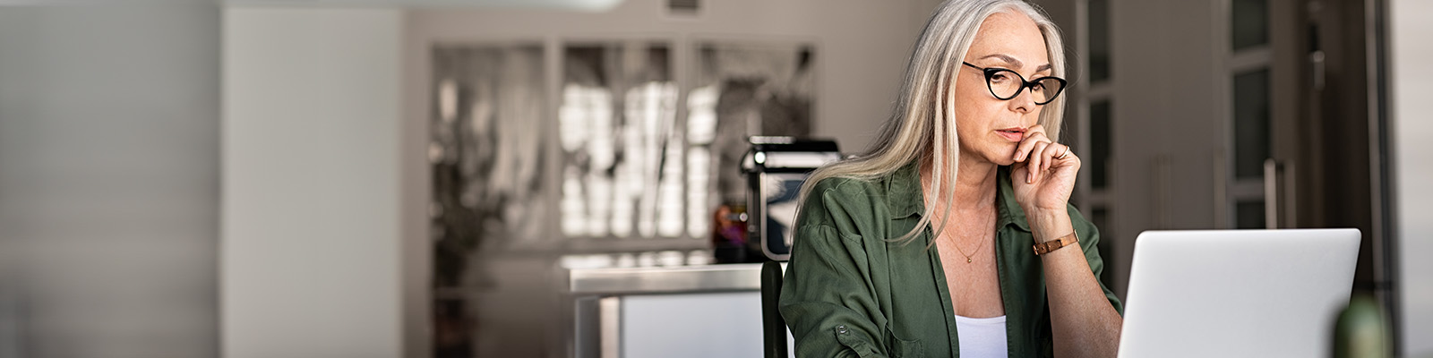 Woman on laptop in kitchen